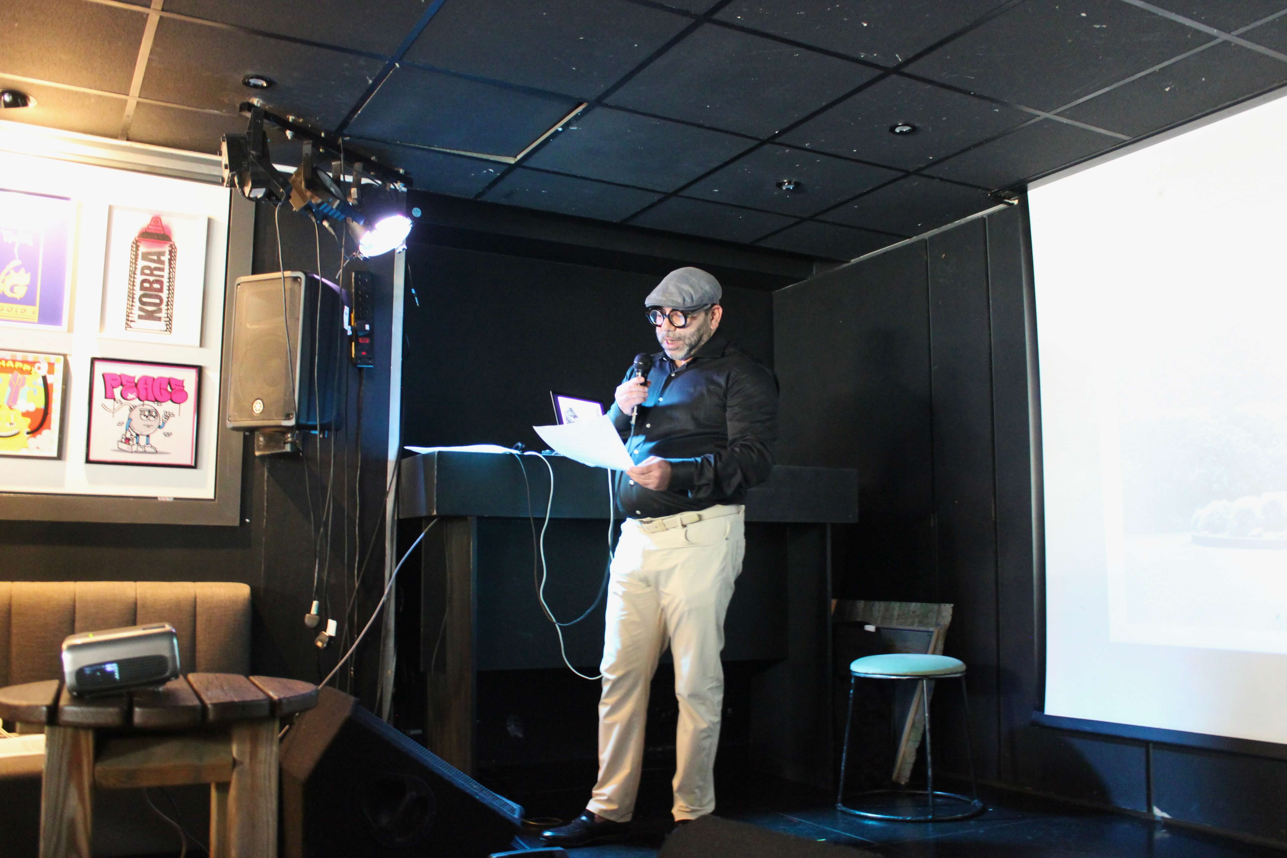 Amir Darwish talking on stage.