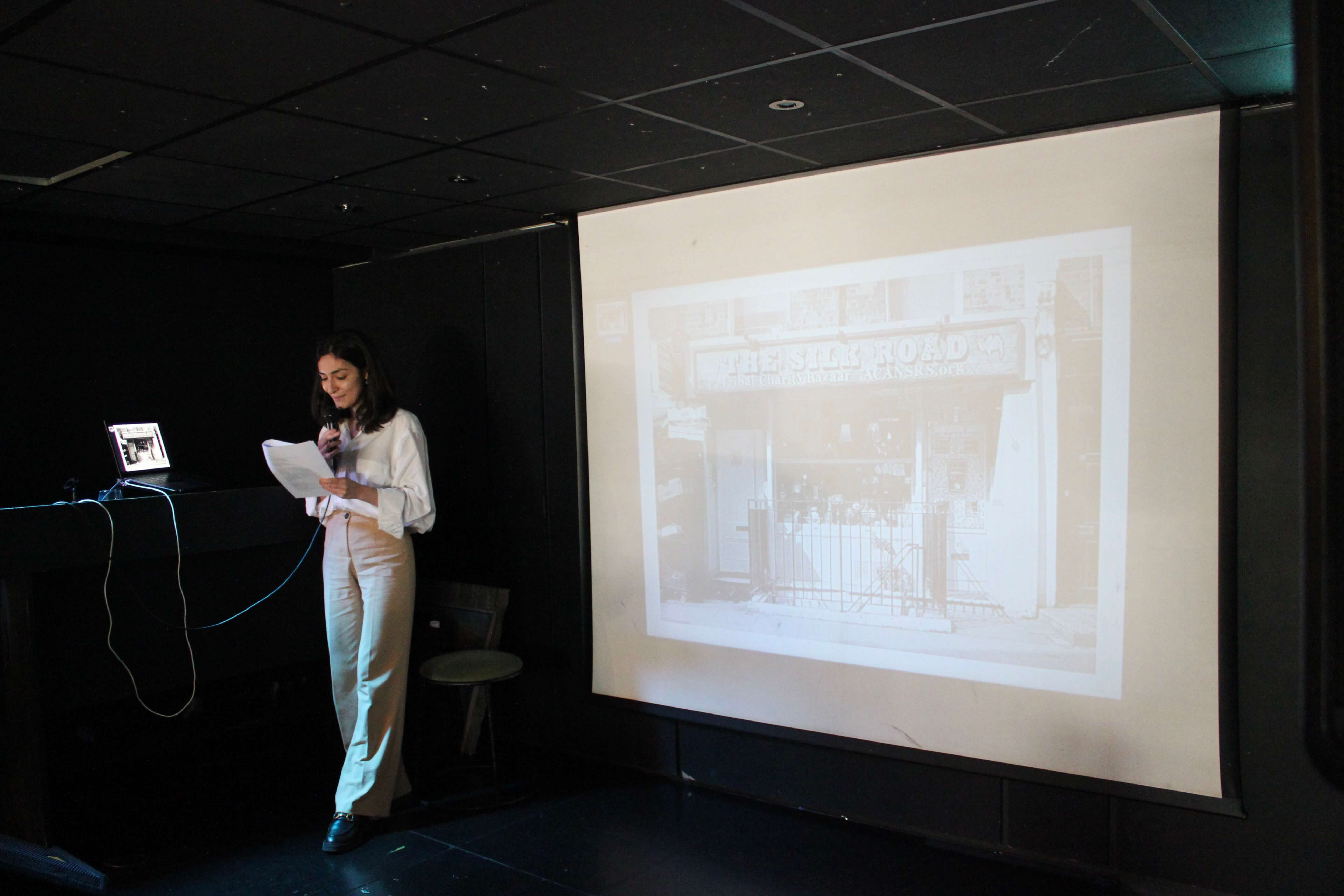 Malika Abdulhamidova talking on stage.